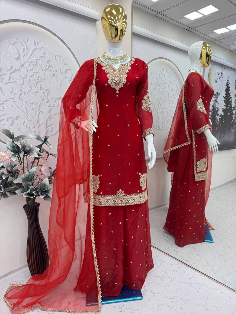 Red traditional outfit with gold embroidery on a mannequin in a store setting. | 5002 Beautiful Fandy Satin Embroidery Worked Kurti With Bottom Dupatta&nbsp;