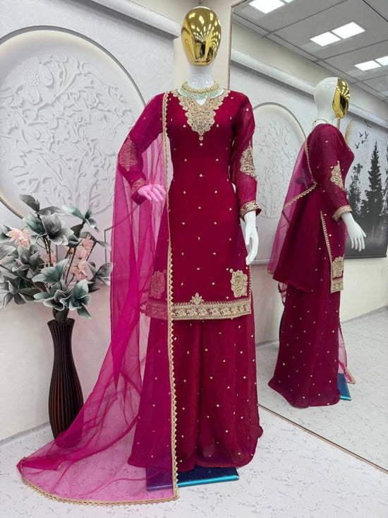 Maroon traditional outfit with gold embroidery on a mannequin in a well-lit room.  5002 Beautiful Fandy Satin Embroidery Worked Kurti With Bottom Dupatta