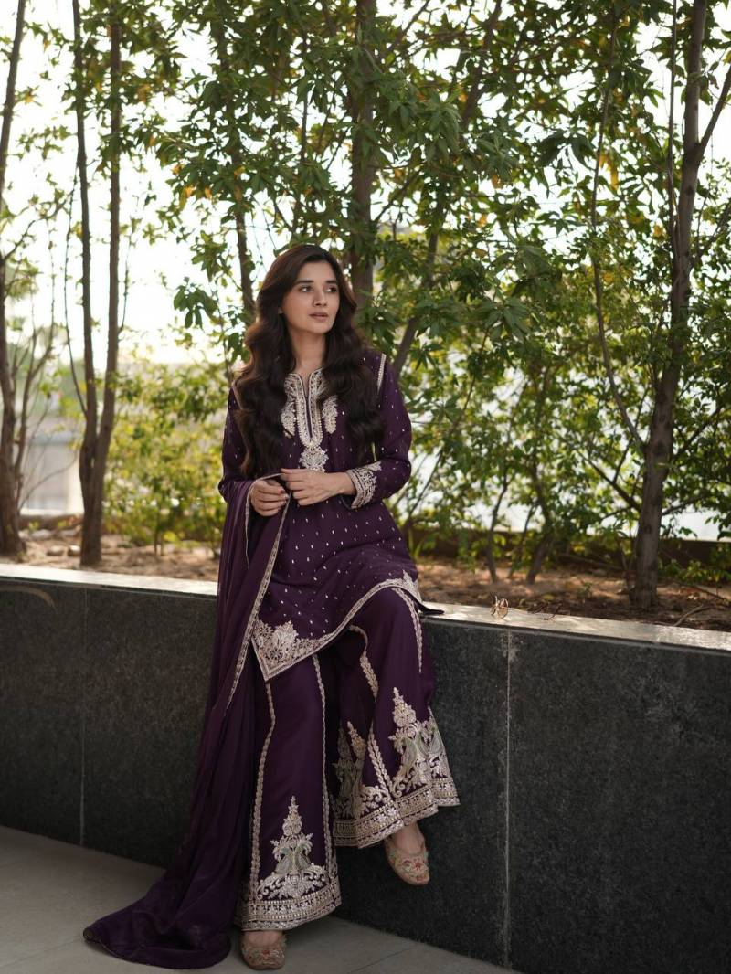Woman in a purple traditional outfit with white embroidery standing outdoors against a natural background. | 5012 Beautiful Star Georgette Embroidery Floral Worked Anarkali Kurti Collection