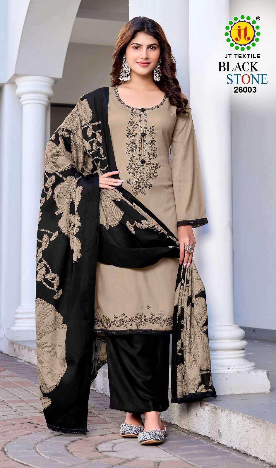 Woman wearing a black and beige traditional outfit with a brand logo in the corner. | JT TEXTILE BLACK STONE VOL-26 26001 TO 26005 SERIES PURE RAYON EMBROIDERY PAKISTANI DRESSES