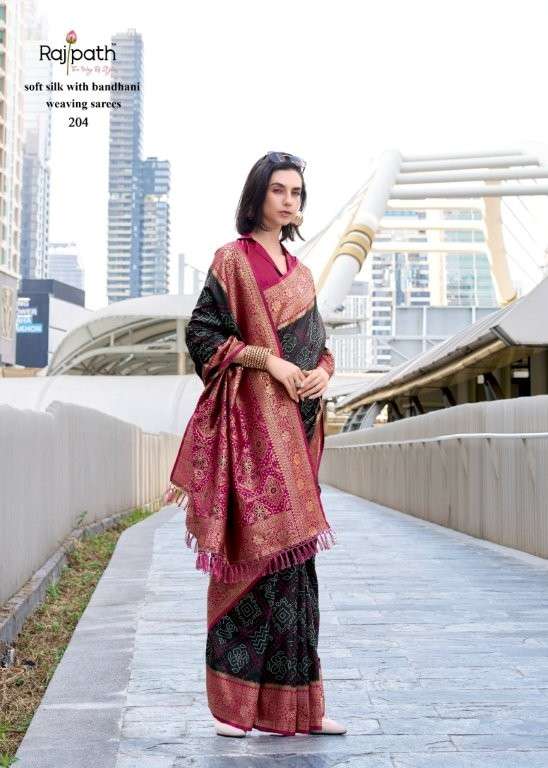 Woman wearing a traditional saree with a cityscape background | RAJPATH Sugandh Silk Pure Silk Bandhani Sarees Catalogue
