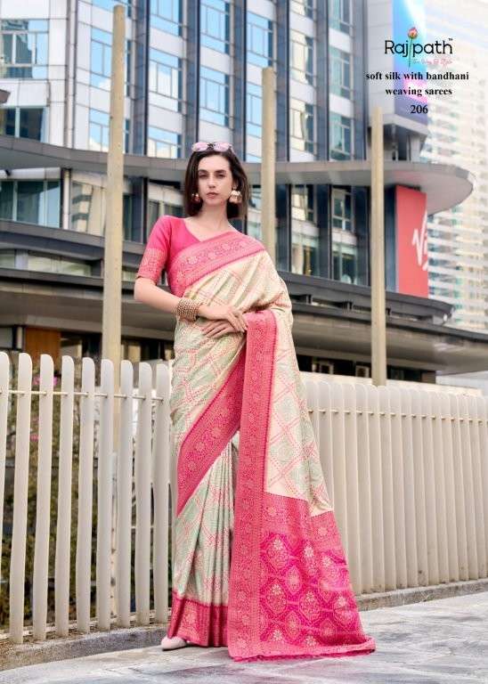 Woman wearing a pink and beige saree with a cityscape background