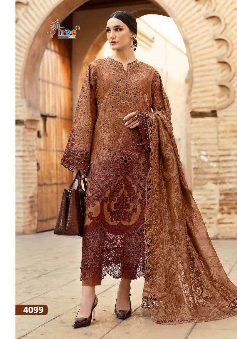 Woman in a brown embroidered dress standing in front of an archway. | SHREE FAB MARIA B VOL-01 Pure Cotton Embroidered Pakistani Dresses Wholesale