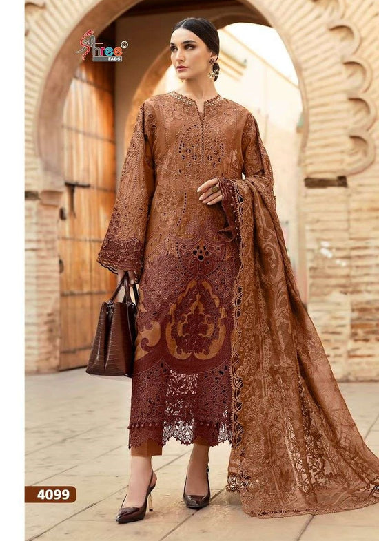 Woman in a brown embroidered dress standing in front of an archway. | SHREE FAB MARIA B VOL-01 Pure Cotton Embroidered Pakistani Dresses Wholesale