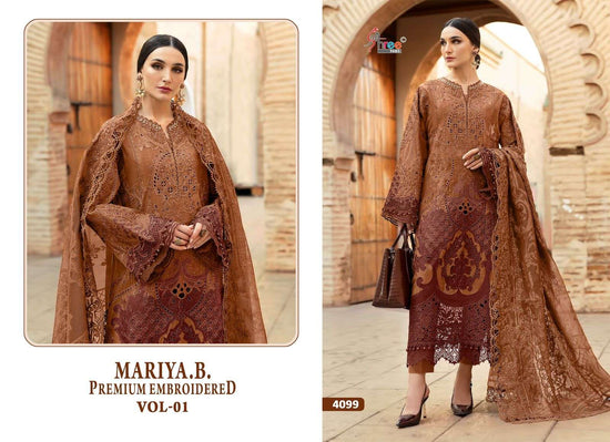 Woman wearing a brown embroidered outfit with a matching shawl in an architectural setting. | SHREE FAB MARIA B VOL-01 Pure Cotton Embroidered Pakistani Dresses Wholesale
