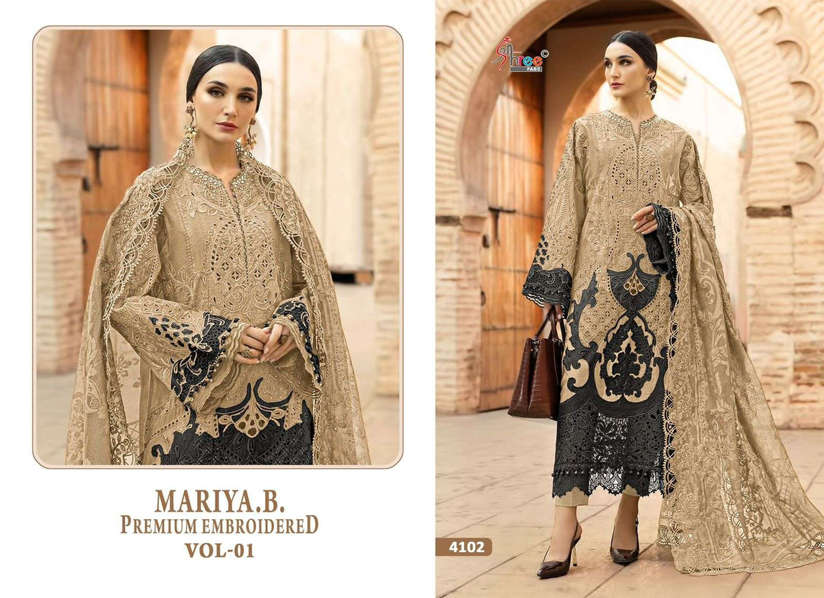 Woman wearing a beige embroidered outfit with black patterns in an outdoor setting. | SHREE FAB MARIA B VOL-01 Pure Cotton Embroidered Pakistani Dresses Wholesale