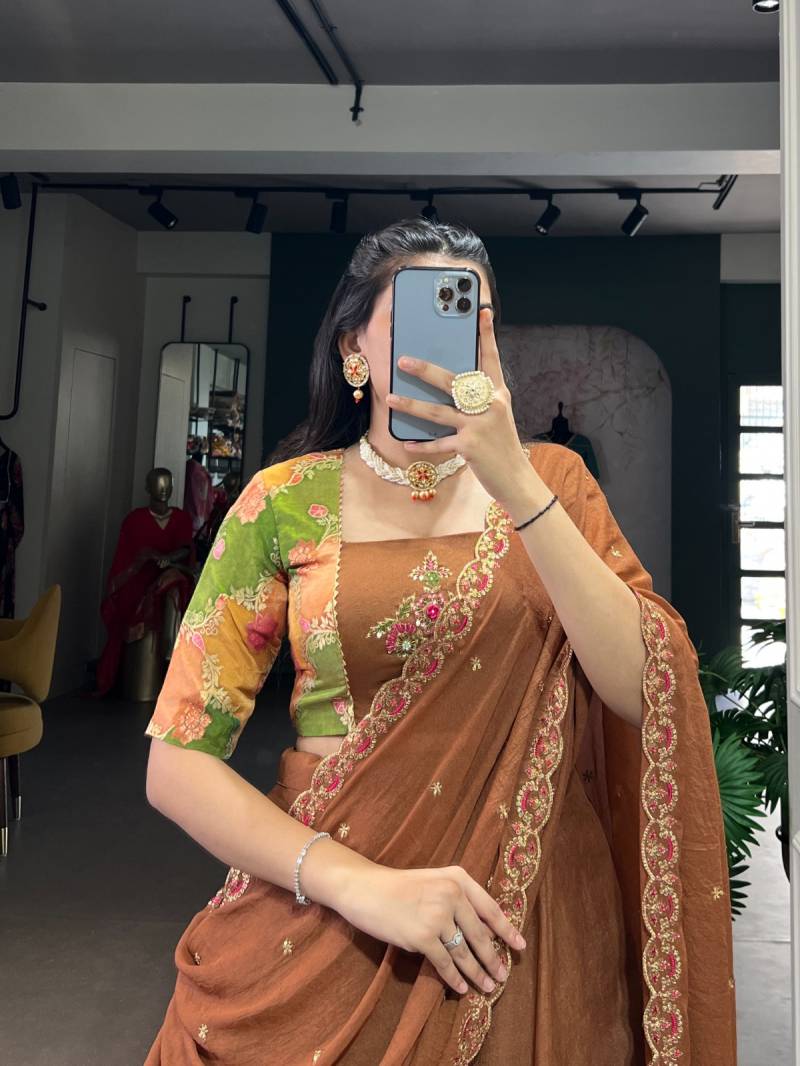 Woman taking a mirror selfie wearing a traditional brown saree with colorful blouse. | Taraa L 1068 Chocolate Crush Plain Lehenga Choli Collection
