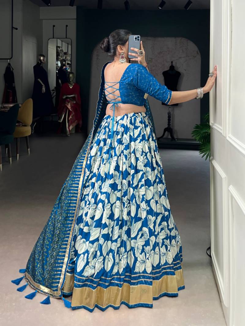 Woman in a blue and white patterned traditional outfit taking a mirror selfie. | Taraa L 1725 Tussar Silk Printed With Foil Worked Lehenga Choli Collection Full Catalog Available at Wholesale Rate