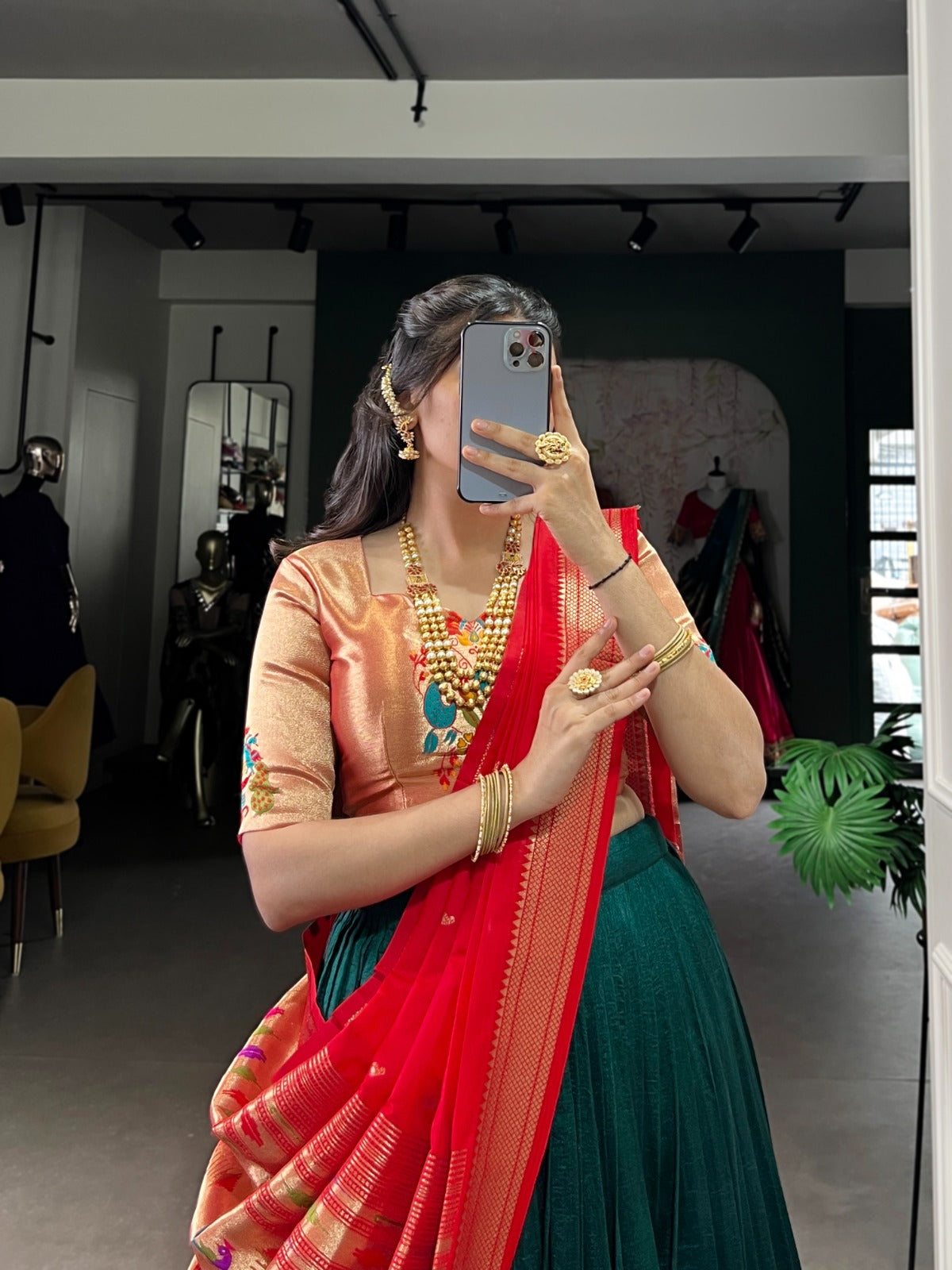 Woman taking a mirror selfie wearing a traditional outfit with a red dupatta in a room. | Taraa L 2007 Vichitra Silk Zari Weaving Plain Lehenga Choli Collection